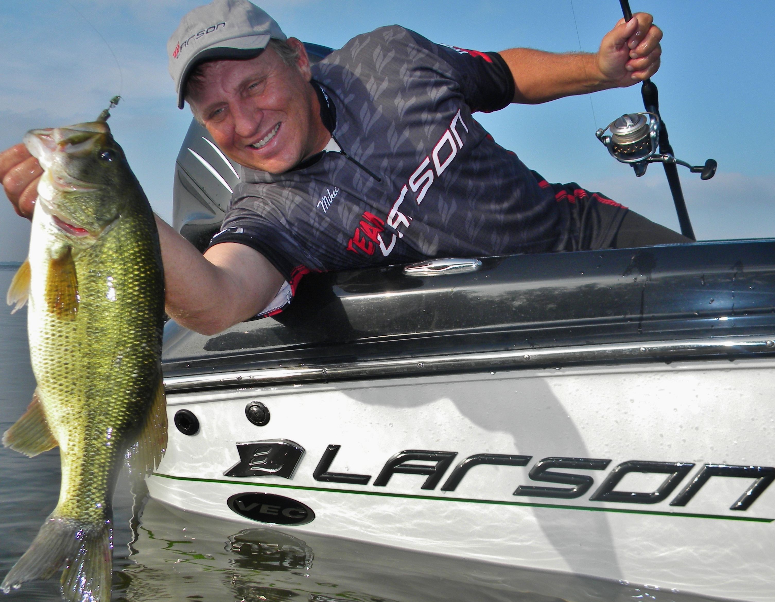 Mike Frisch holding up a summertime largemouth that he caught fishing.