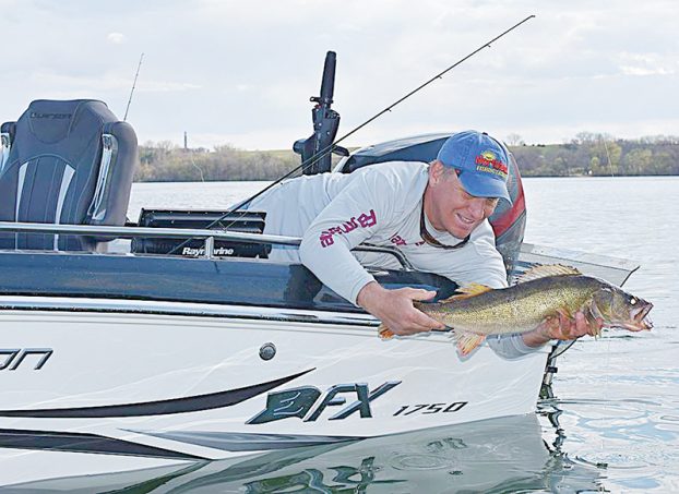 Fisherman Mike Frisch holding up a walleye.