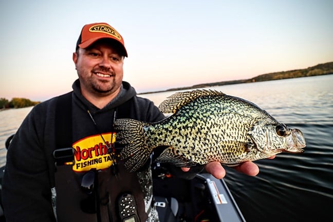 Angler holding up a crappie caught on a Northland Fishing Tackle crappie jig