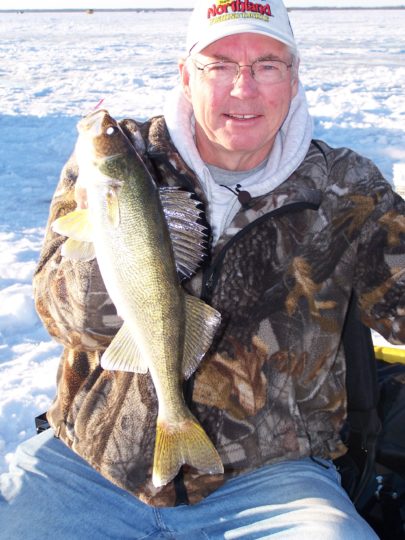 Ice Fisherman with a walleye