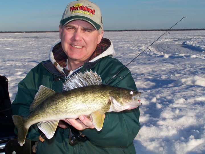 Ice fisherman with a walleye