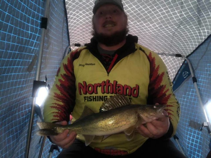 Ice fisherman with a walleye he caught