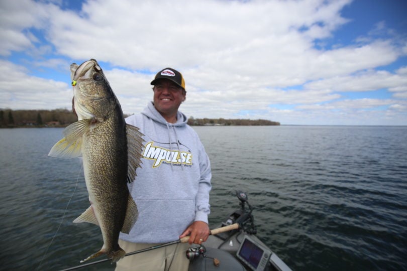 Tony Roach holding up a walleye he caught on the Northland Fishing Tackle Deep-Vee jig.