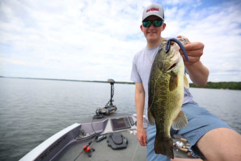 Angler with a largemouth bass caught in June