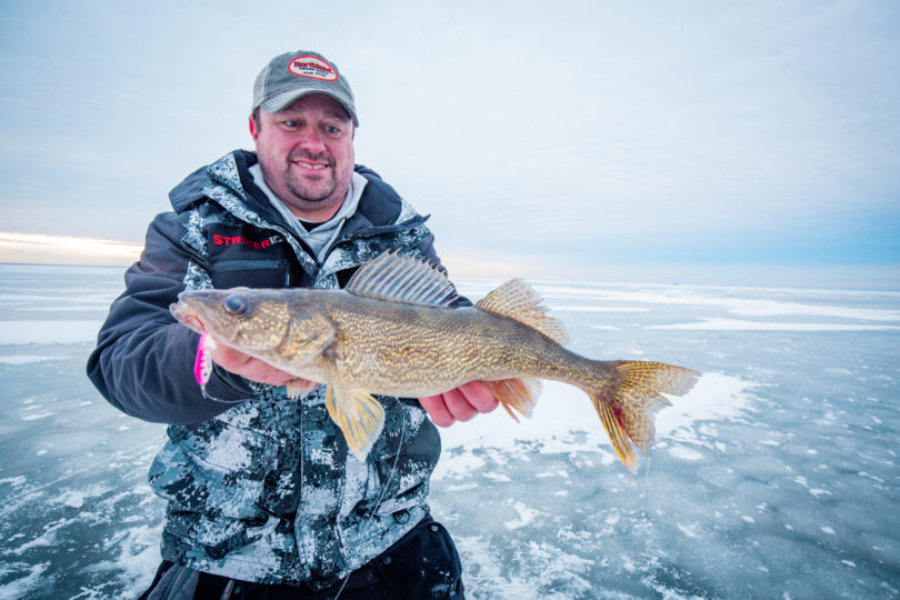 Joel Nelson with a walleye he caught ice fishing with a jigging spoon
