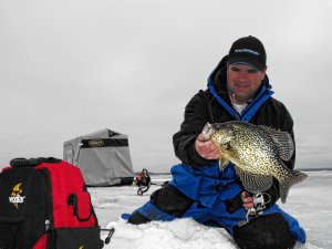 Jason Mitchell holding a crappie caught ice fishing