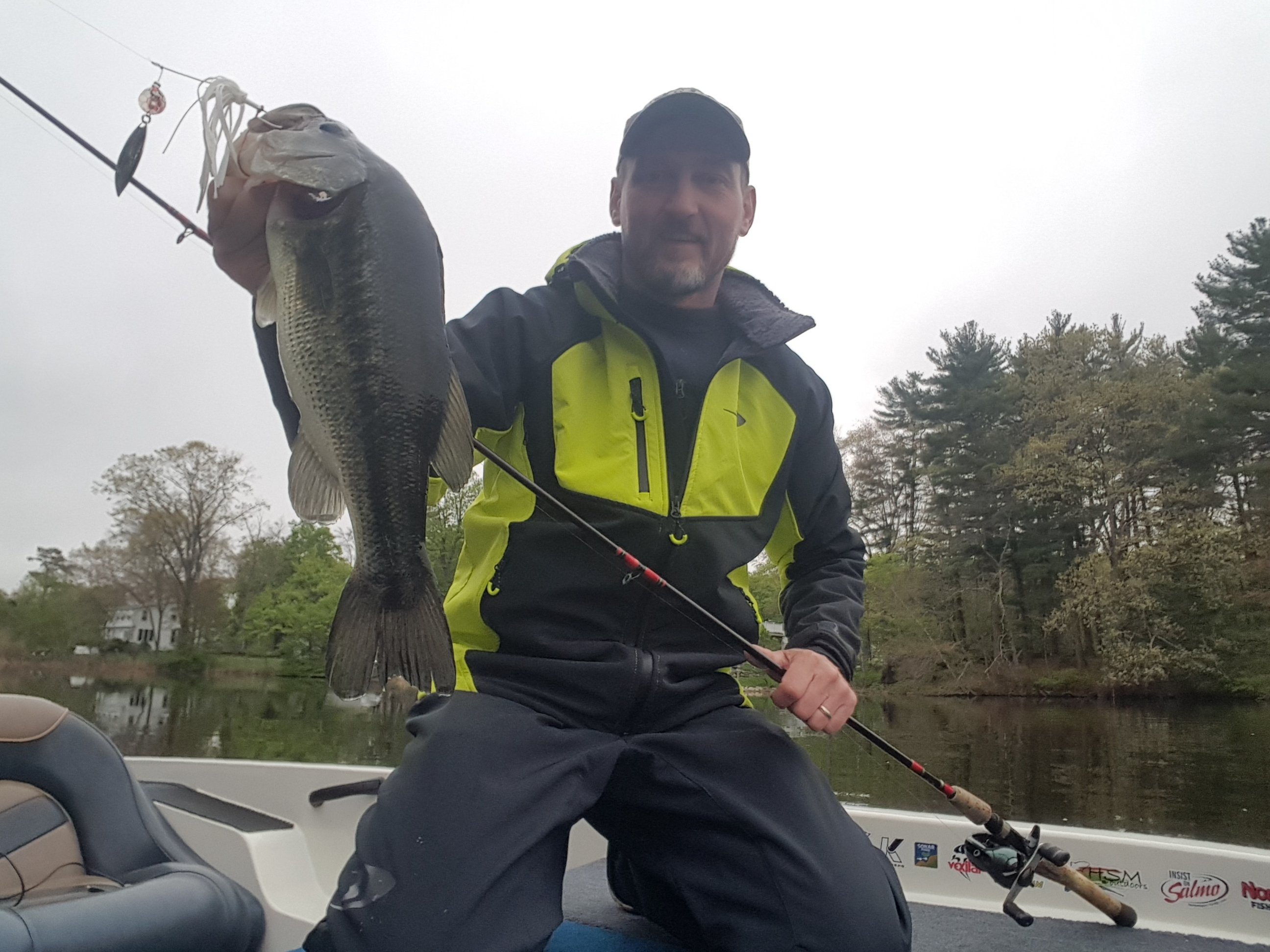 Fisherman holding up a big largemouth caught on a Reed Runner Spinnerbait.
