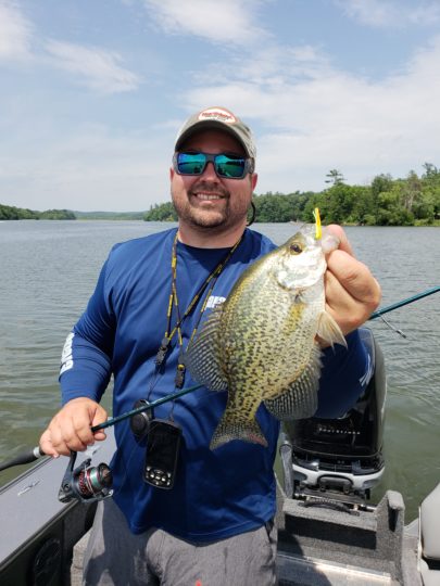 Angler holding up a crappie caught on a small Northland Tackle jig