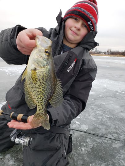 Youth fisherman with a ice first crappie