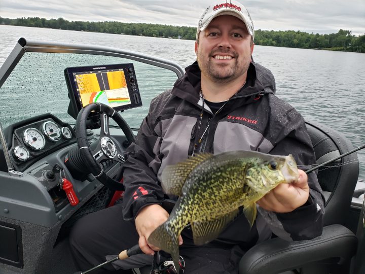 Joel Nelson holding up a crappie he caught