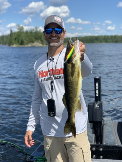 Fisherman holding up a walleye he caught on the Northland Fishing Tackle Rumble Shiner.