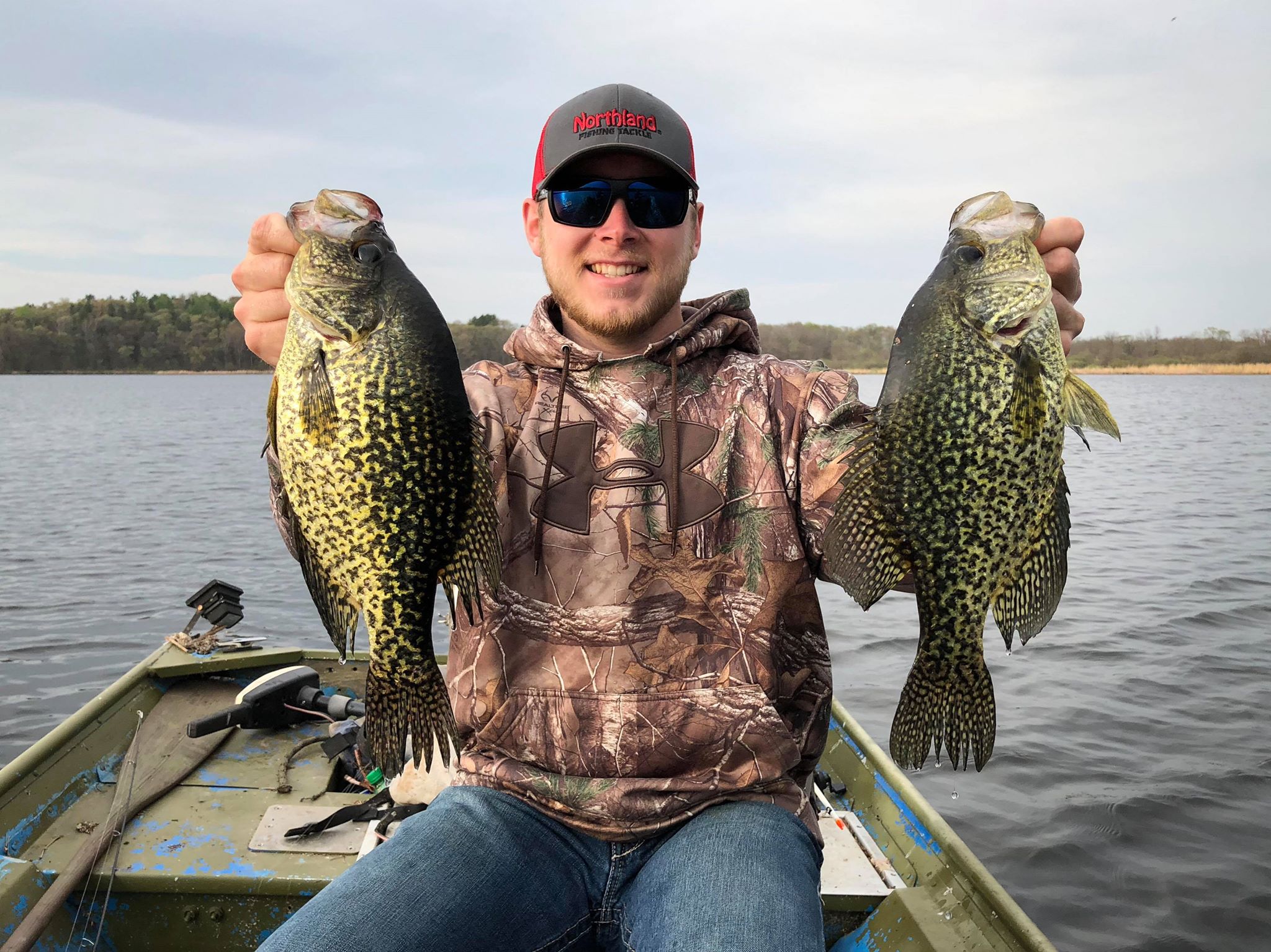 Fisherman with two spring crappies