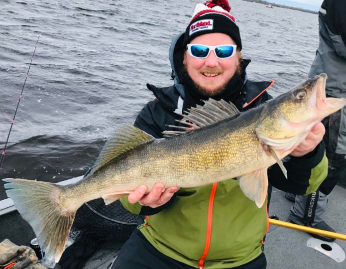 An angler fishing cold water with a walleye.