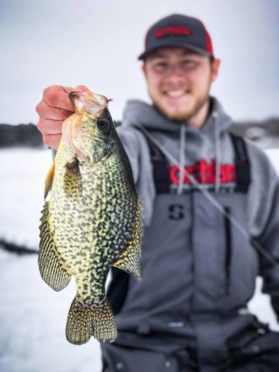 A good sized crappie caught ice fishing with a small jig.