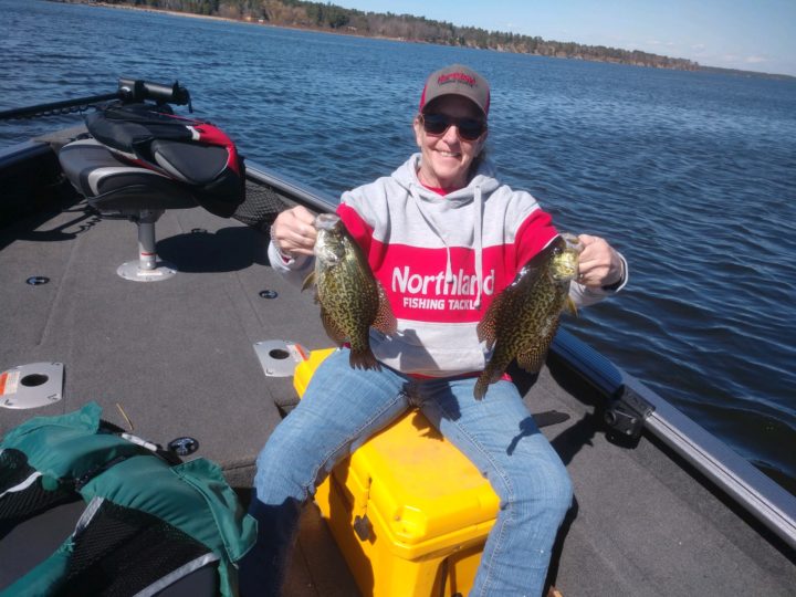 Angler with two early spring crappies