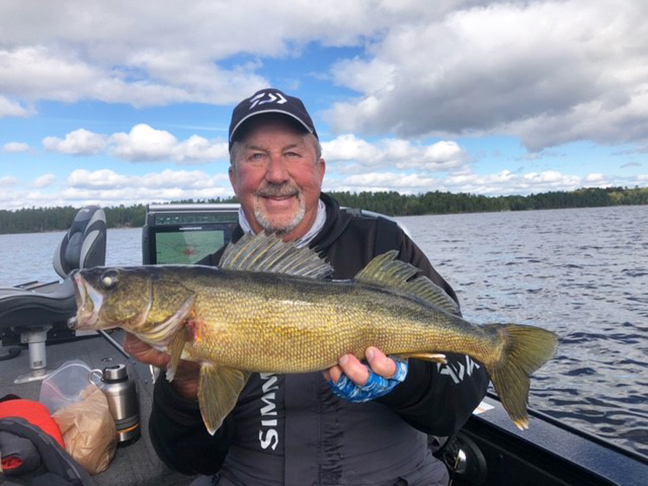 Fishing Angler holding walleye fish