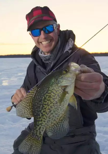 Cheep Leer showing off a crappie he caught ice fishing.