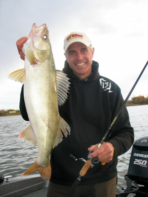 Chip Leer holding up a walleye caught in the spring.