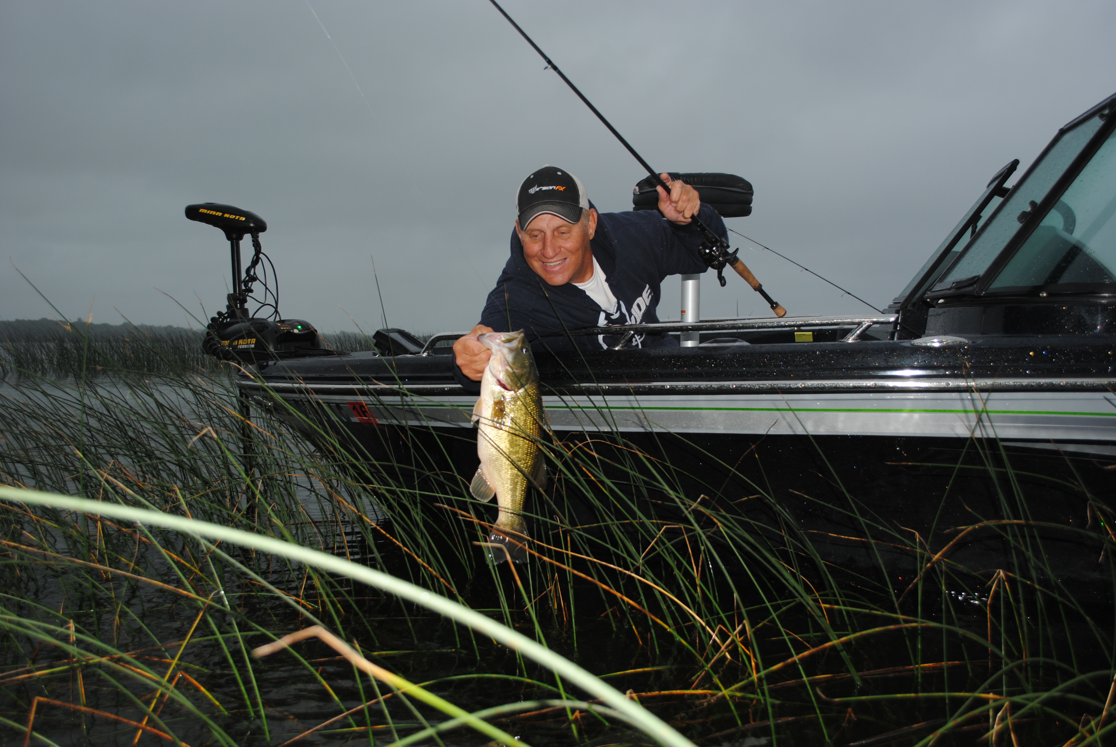 Mike Frisch catching bass in pencil reeds.