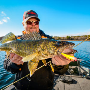 Brian 'Bro' Brosdahl holding up a walleye he caught on the Rumble Shad crankbait