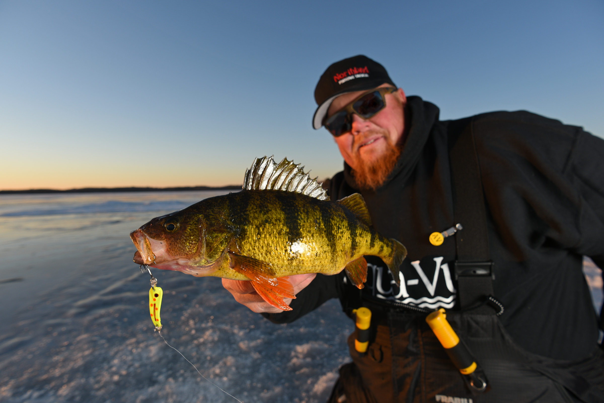 Bro with a perch caught ice fishing on a Glo-Shot Spoon