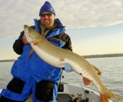 Dan Burrow holding up a Muskie caught on Mille Lacs.