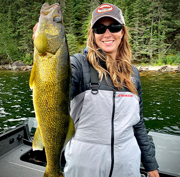 DockTalk-366x361 Female fisherman holding up a walleye she caught fishing.