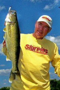 John Peterson holding up a big walleye.