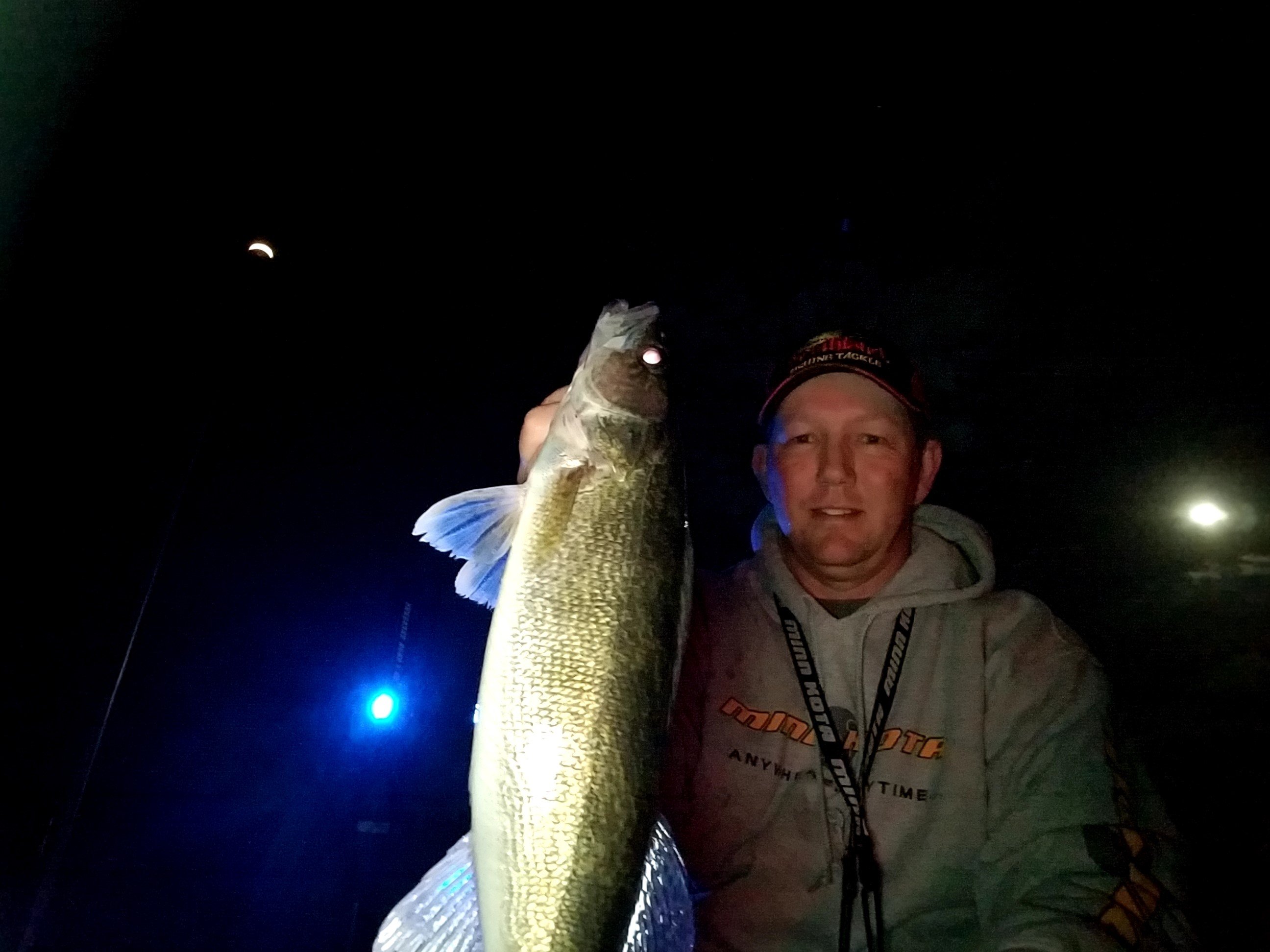 Angler night fishing for walleyes with lighted bobbers