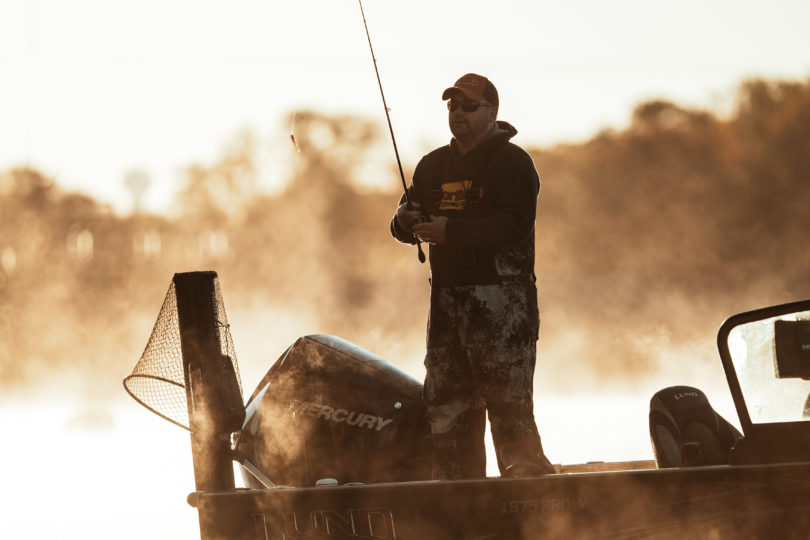 Fisherman fishing on a lake in the fall