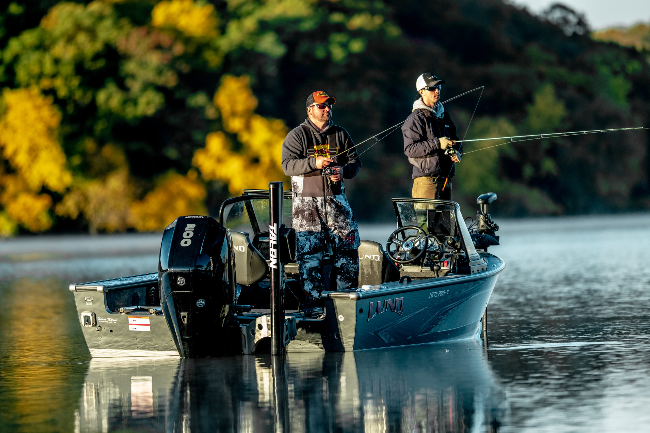 Two fisherman on the lake in the fall fishing