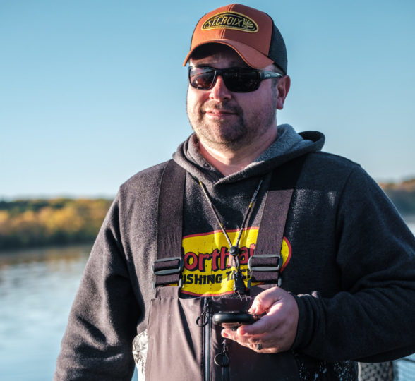 Fisherman using trolling motor remote