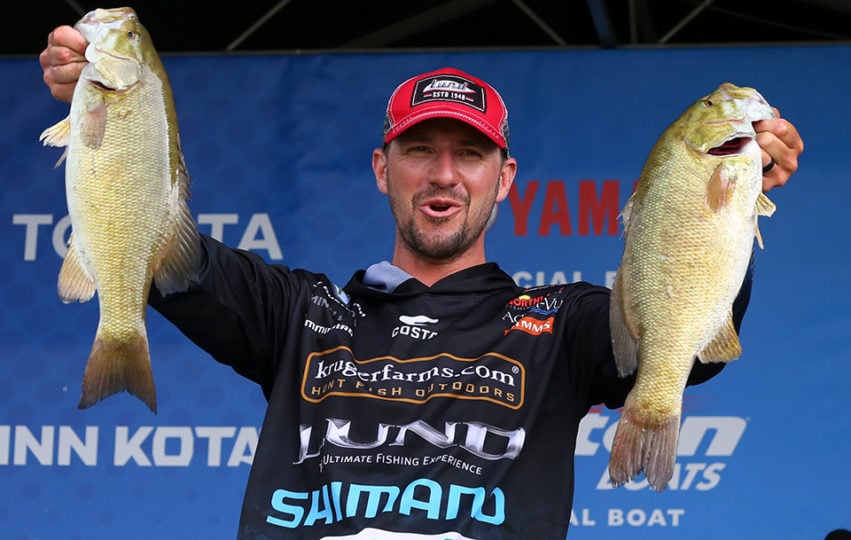 Gussy holding up a pair of smallmouth he caught during the 2019 Elite Series.