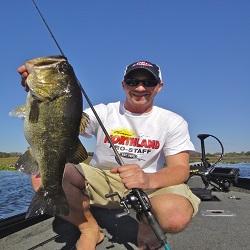 Jeff 'Gussy' Gustafson holding up a summertime bass