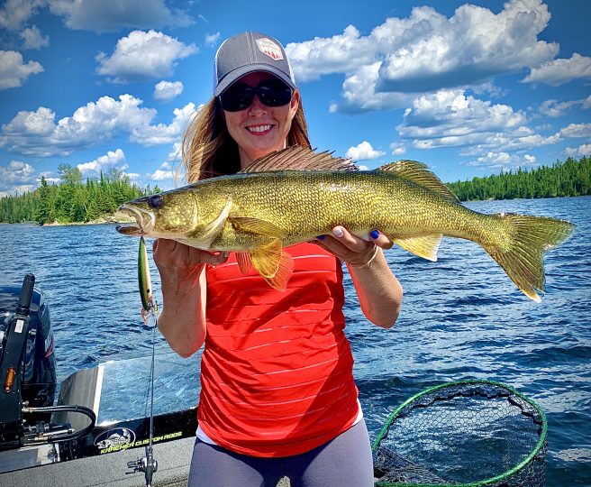 Sara Trampe holding up a walleye she caught on the Rumble Shiner crankbait.