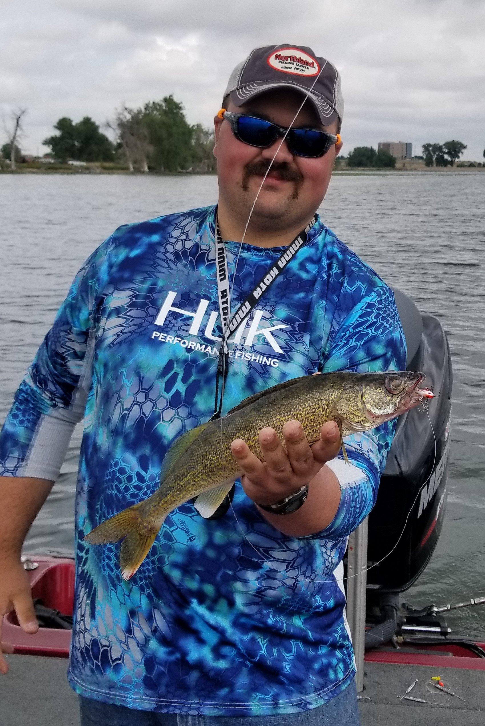Fisherman with a walleye he caught during the summer