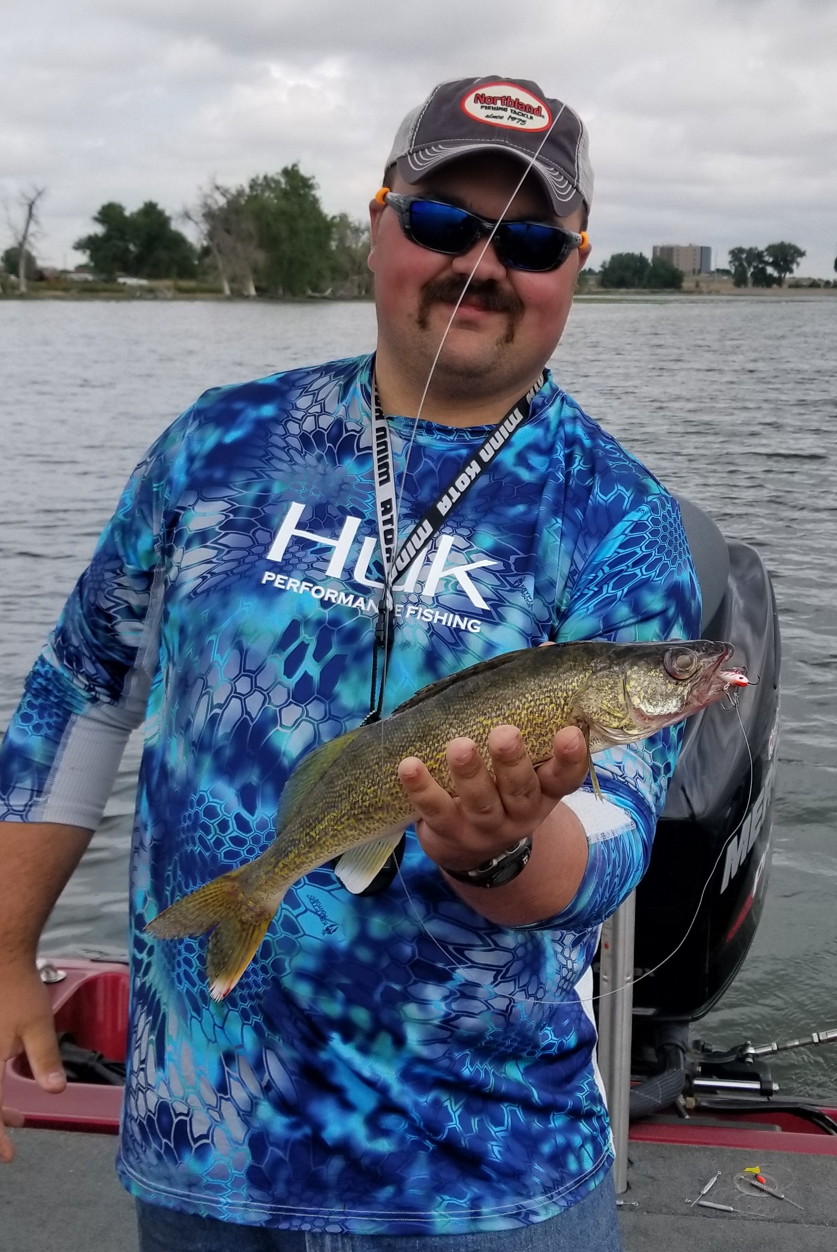 Fisherman with a walleye he caught during the summer