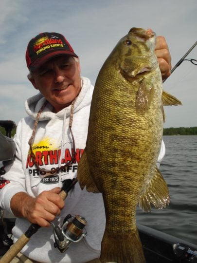Angler with a smallmouth bass caught during the fall