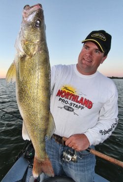 Jason Mitchell holding up a walleye caught under a slip bobber.