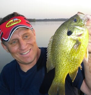 Mike Frisch holding up a bluegill he caught.