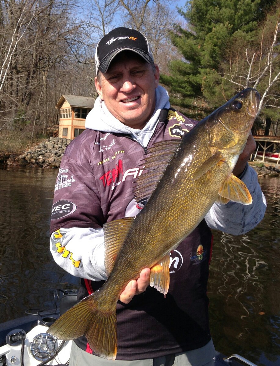 Fisherman Mike Frisch holding up a walleye he caught.