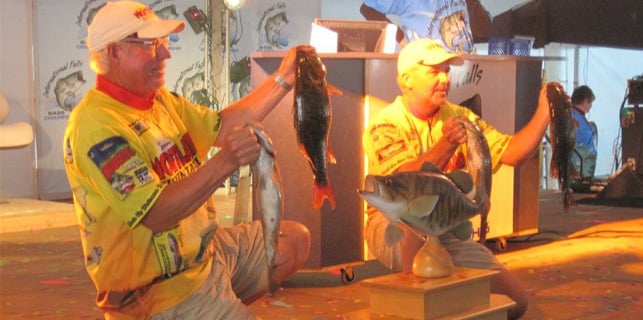 John and Duane Peterson holding up their catch at a tournament.