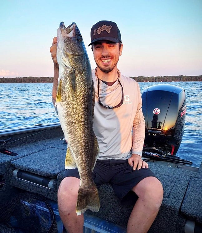 Nick Lindner holding up a walleye he caught.