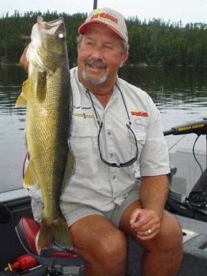Tom Neustrom holding up a spring walleye