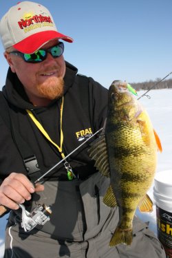 Brian 'Bro' Brosdahl with a yellow perch he caught ice fishing.