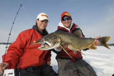 Jeff Gustafson and Mandy with a lake trout they caught ice fishing.