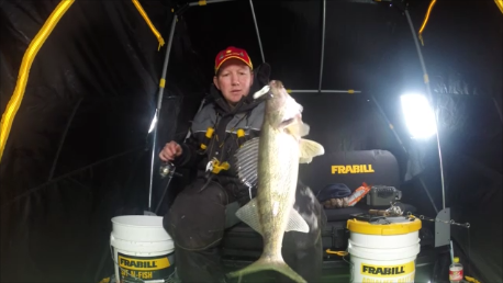 A fisherman with a walleye he caught when ice fishing in South Dakota.