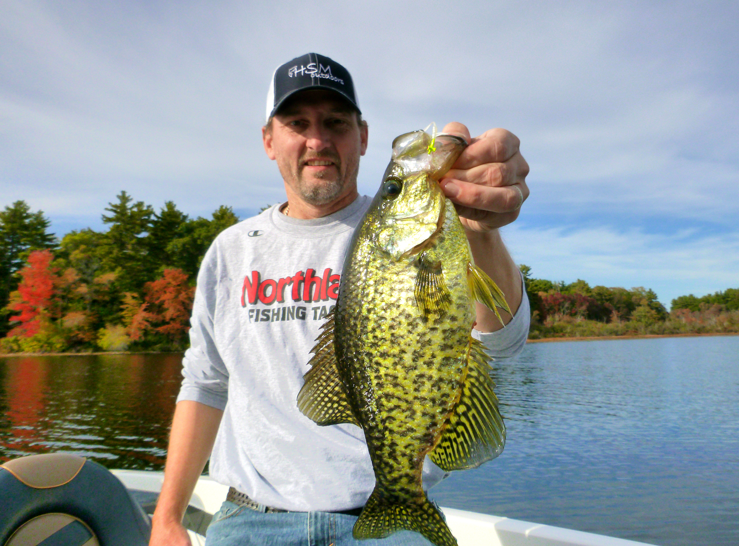 Fisherman holding up a fall time crappie he caught fishing.