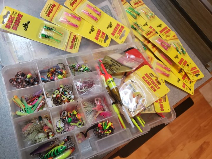 Tackle box with Northland Fishing Tackle jigs and lures in it.