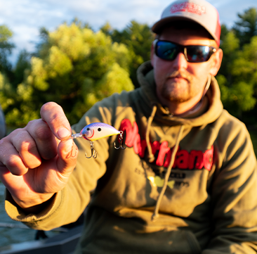 Fisherman holding up a Northland Fishing Tackle Rumble Series Crankbait.